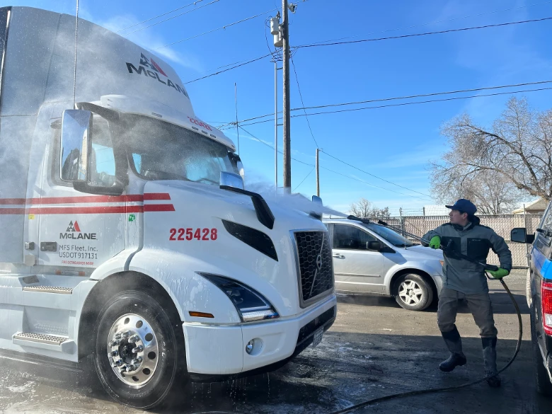 Jaime washing the Mclane fleet trucks